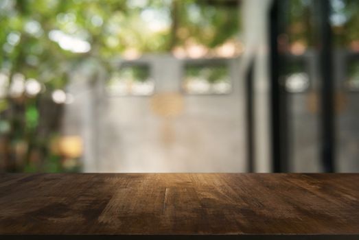 Empty wooden table in front of abstract blurred background of coffee shop . can be used for display or montage your products.Mock up for display of product