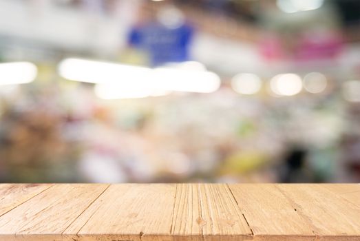 Empty wooden table in front of abstract blurred background of coffee shop . can be used for display or montage your products.Mock up for display of product