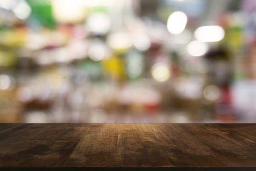 Empty wooden table in front of abstract blurred background of coffee shop . can be used for display or montage your products.Mock up for display of product