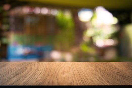 Empty wooden table in front of abstract blurred background of coffee shop . can be used for display Mock up  of product.