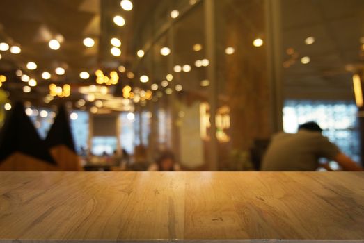 Empty wooden table in front of abstract blurred background of bokeh light . can be used for display or montage your products.Mock up for display of product.