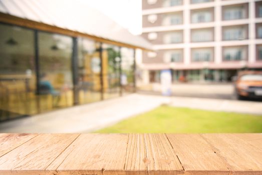 Empty wooden table in front of abstract blurred background of coffee shop . can be used for display Mock up  of product.