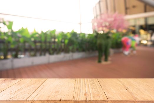 Empty wooden table in front of abstract blurred background of coffee shop . can be used for display Mock up  of product.