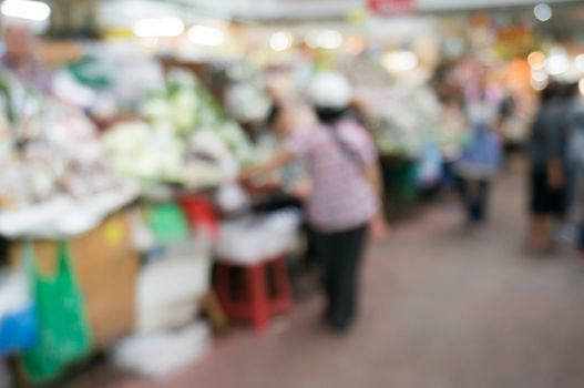 Blurred background of people shopping at night market festival for background usage