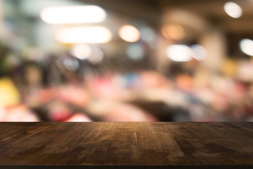 Empty wooden table in front of abstract blurred background of coffee shop . can be used for display Mock up  of product.