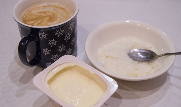 Healthy quick Breakfast. Yogurt rice porridge and coffee.