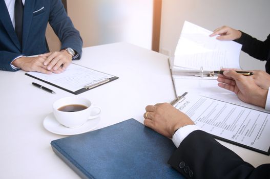 Examiner reading a resume during  job interview at office Business and human resources concept.