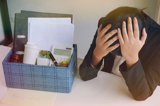 Business woman moving offices packing up Cardboard Box in office