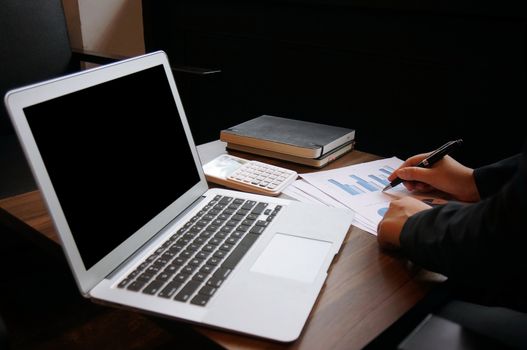 Business woman working on Laptop with Mock up blank screen. technology concept.