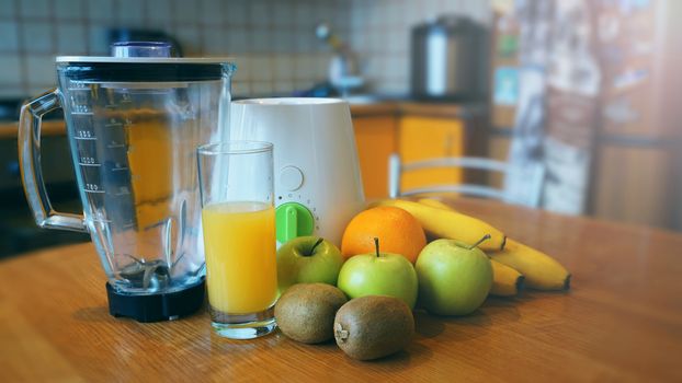 fresh fruits and kitchen interior and wooden table place - apples, kiwi, oranges