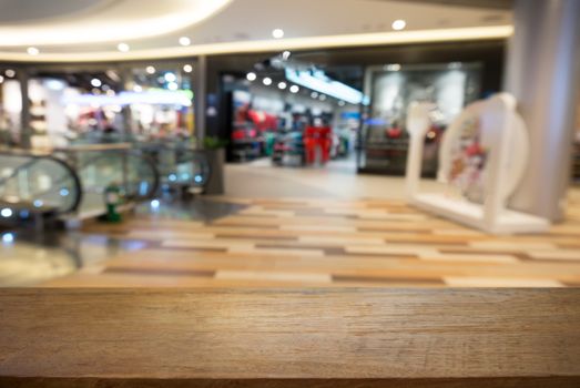 Empty wooden table in front of abstract blurred background of coffee shop . can be used for display Mock up  of product.