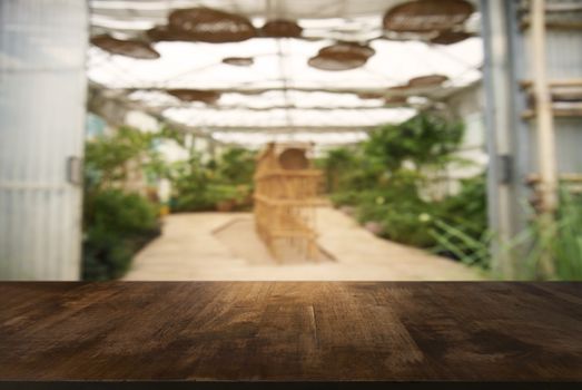 Empty wooden table in front of abstract blurred background of coffee shop . can be used for display or montage your products.Mock up for display of product