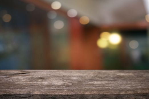 Empty wooden table in front of abstract blurred background of coffee shop . can be used for display or montage your products.Mock up for display of product