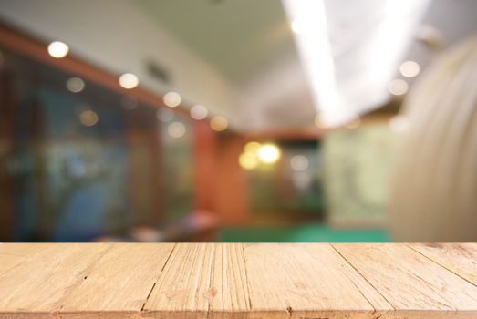 Empty wooden table in front of abstract blurred background of coffee shop . can be used for display or montage your products.Mock up for display of product