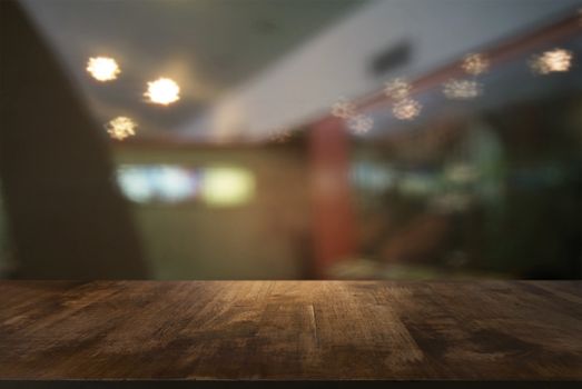 Empty wooden table in front of abstract blurred background of coffee shop . can be used for display or montage your products.Mock up for display of product