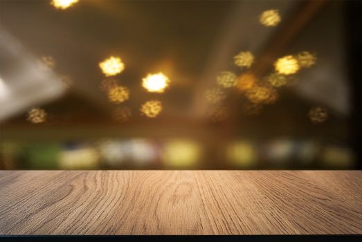 Empty wooden table in front of abstract blurred background of coffee shop . can be used for display or montage your products.Mock up for display of product