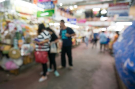 Blurred background of people shopping at night market festival for background usage