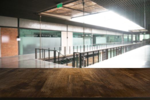 Empty wooden table in front of abstract blurred background of coffee shop . can be used for display Mock up  of product.