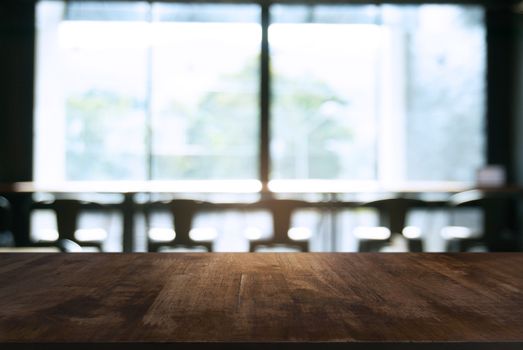 Empty wooden table in front of abstract blurred background of coffee shop . can be used for display Mock up  of product.