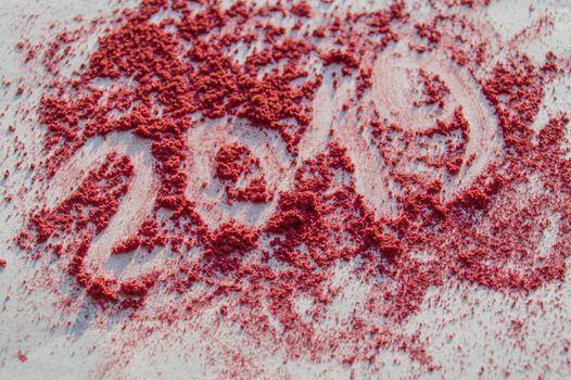 Crushed blush and powder in fashionable bright colors on white background. The inscription 2019.
