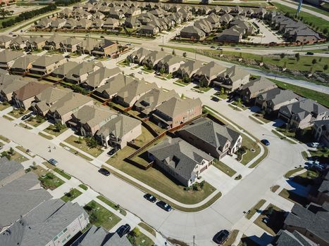 Aerial view new development community with row of detached single-family house and garden. Flyover residential area suburban Dallas, Texas, USA