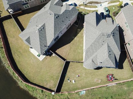 Aerial straight down view of brand new single-family houses with garden, wooden fence near Dallas, Texas, USA