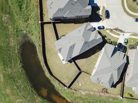 Aerial straight down view of brand new single-family houses with garden, wooden fence near Dallas, Texas, USA