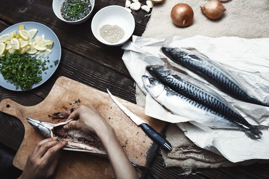 Woman preparing mackerel fish