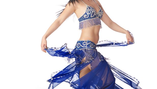 Belly dancer in blue traditional dress on a white background