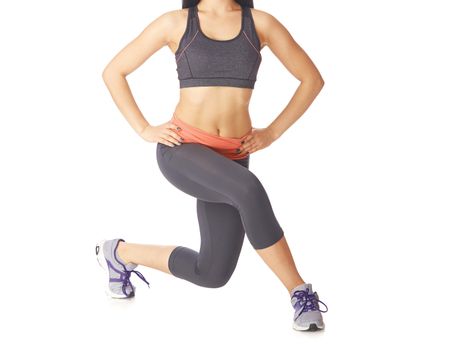 Woman doing fitness exercise on a white studio background