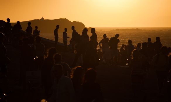 silhouettes of people taking pictures with smartphones and Greek flag