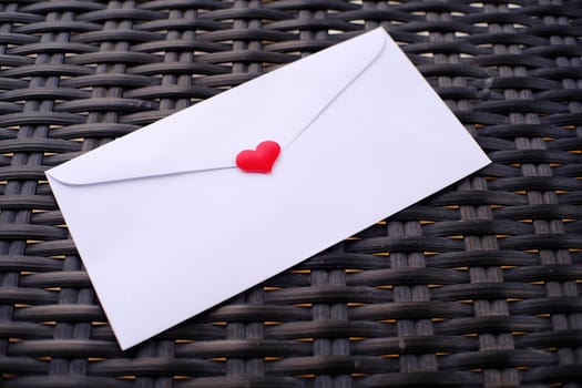 Valentine's day love letter envelope with hearts on wooden background. copy space