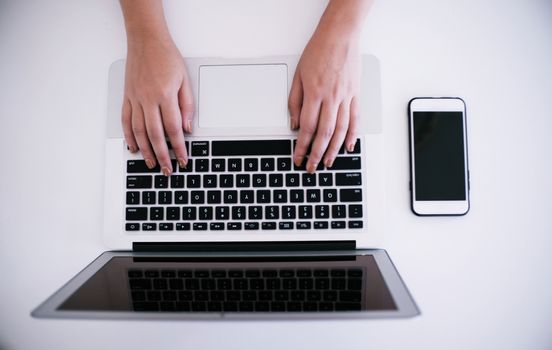 The Casual business woman works online on laptop which hand on keyboard in her house Isolated screen