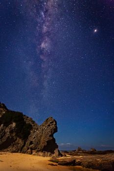 Clear starry skies and the Milky Way universe shines brightly  over Queen Victoria Rock on far south coast of NSW.