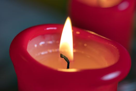 Image of two red burning candels on a table
