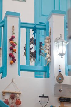 traditional narrow street in Mykonos with blue doors and white walls