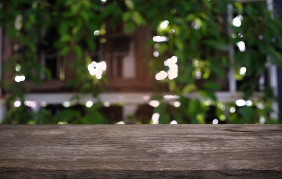 Empty dark wooden table in front of abstract blurred bokeh background of restaurant . can be used for display or montage your products.Mock up for space