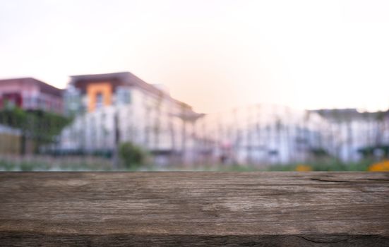 Empty dark wooden table in front of abstract blurred bokeh background of restaurant . can be used for display or montage your products.Mock up for space