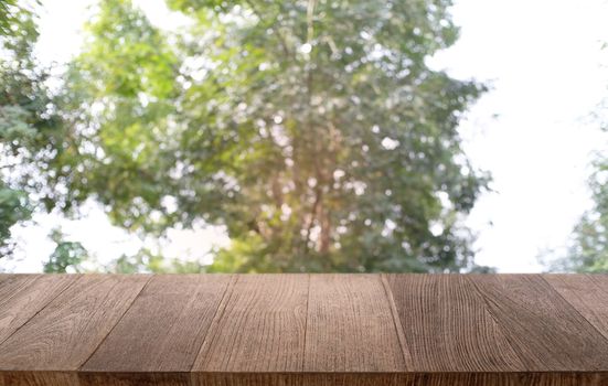 Empty dark wooden table in front of abstract blurred bokeh background of restaurant . can be used for display or montage your products.Mock up for space