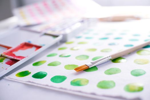 Watercolor paints and brushes workplace artist with artistic tools for mock up