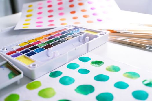 Watercolor paints and brushes workplace artist with artistic tools for mock up