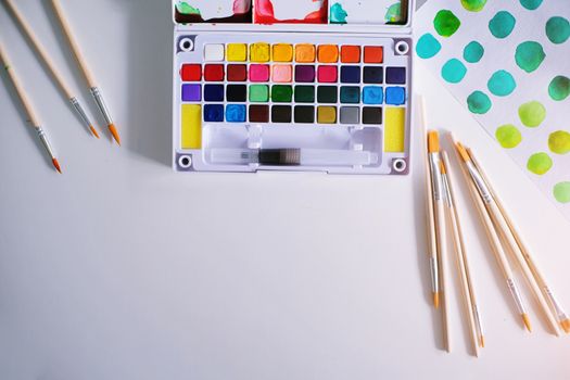 Watercolor paints and brushes workplace artist with artistic tools for mock up