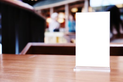 Menu frame standing on wood table in Bar restaurant cafe. space for text marketing promotion