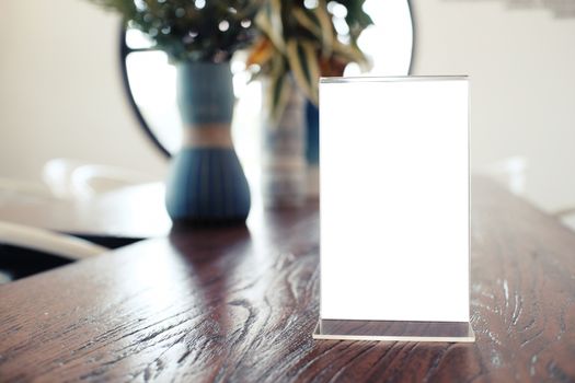 Menu frame standing on wood table in Bar restaurant cafe. space for text marketing promotion