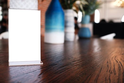 Menu frame standing on wood table in Bar restaurant cafe. space for text marketing promotion