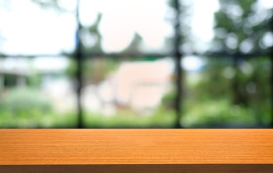 Empty dark wooden table in front of abstract blurred bokeh background of restaurant . can be used for display or montage your products.Mock up for space