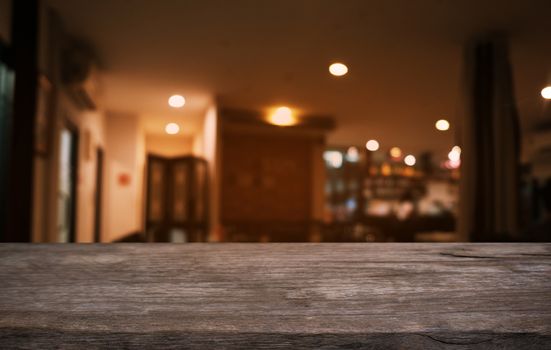 Empty dark wooden table in front of abstract blurred bokeh background of restaurant . can be used for display or montage your products.Mock up for space