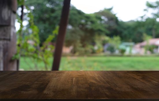 Empty dark wooden table in front of abstract blurred bokeh background of restaurant . can be used for display or montage your products.Mock up for space