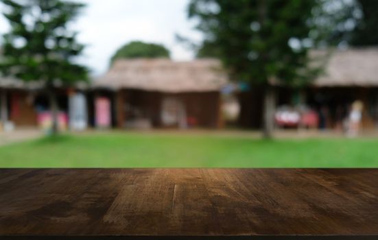 Empty dark wooden table in front of abstract blurred bokeh background of restaurant . can be used for display or montage your products.Mock up for space