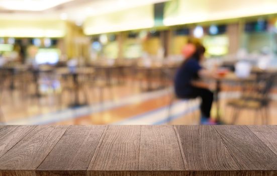 Empty dark wooden table in front of abstract blurred bokeh background of restaurant . can be used for display or montage your products.Mock up for space